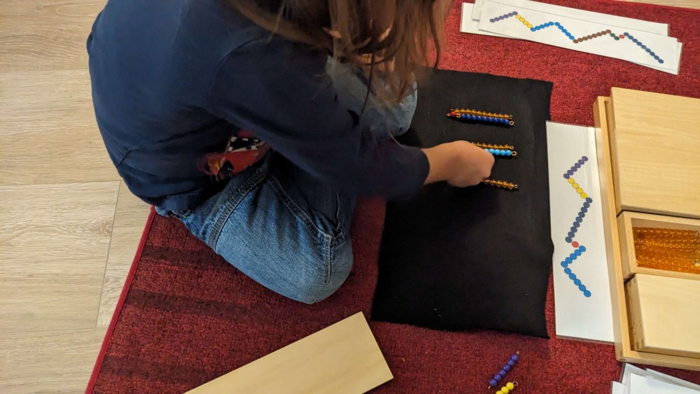 Travail sur les quantités avec les perles Montessor Serpent de l'addition avec les perles colorées.